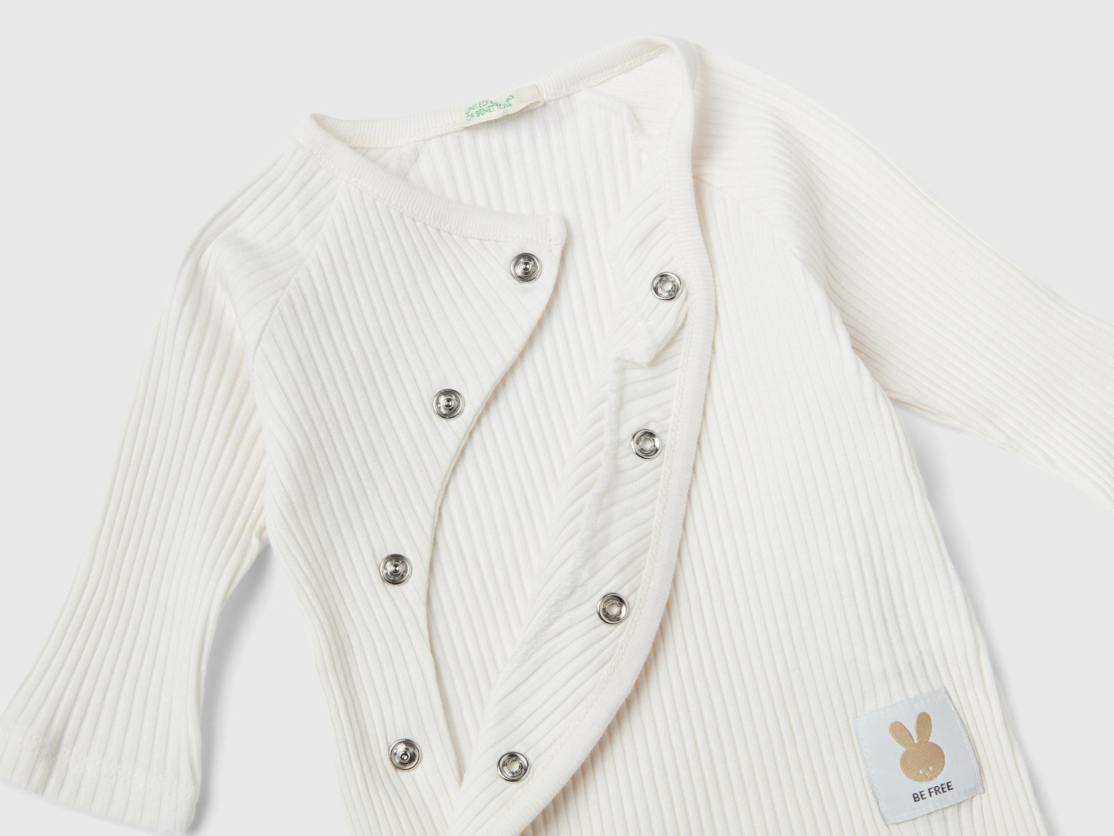 Tutina a costine in cotone bio da neonato bianco panna 2 | Benetton Outlet