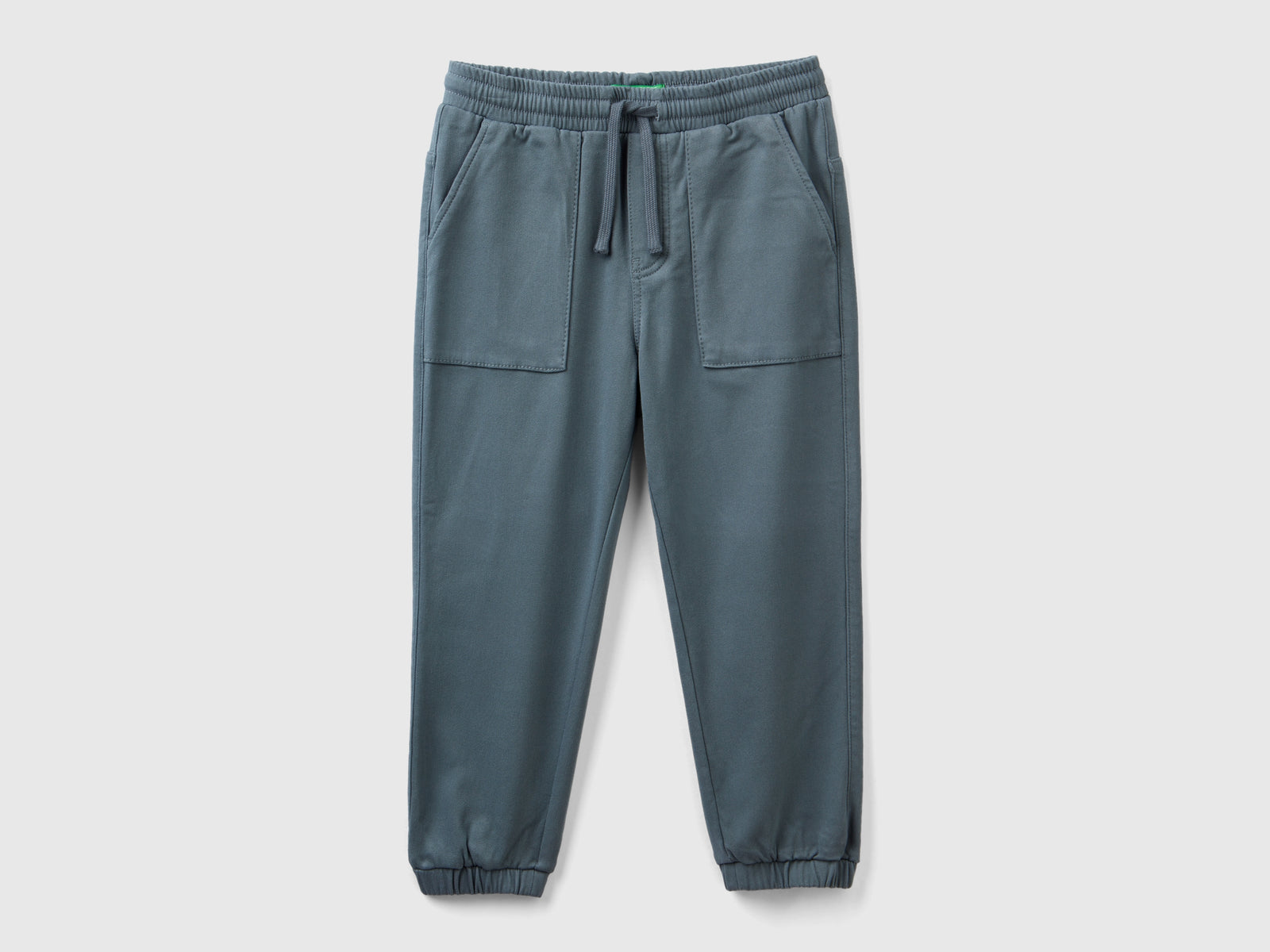 Joggers con coulisse e maxi tasche da bambino grigio scuro | Benetton Outlet