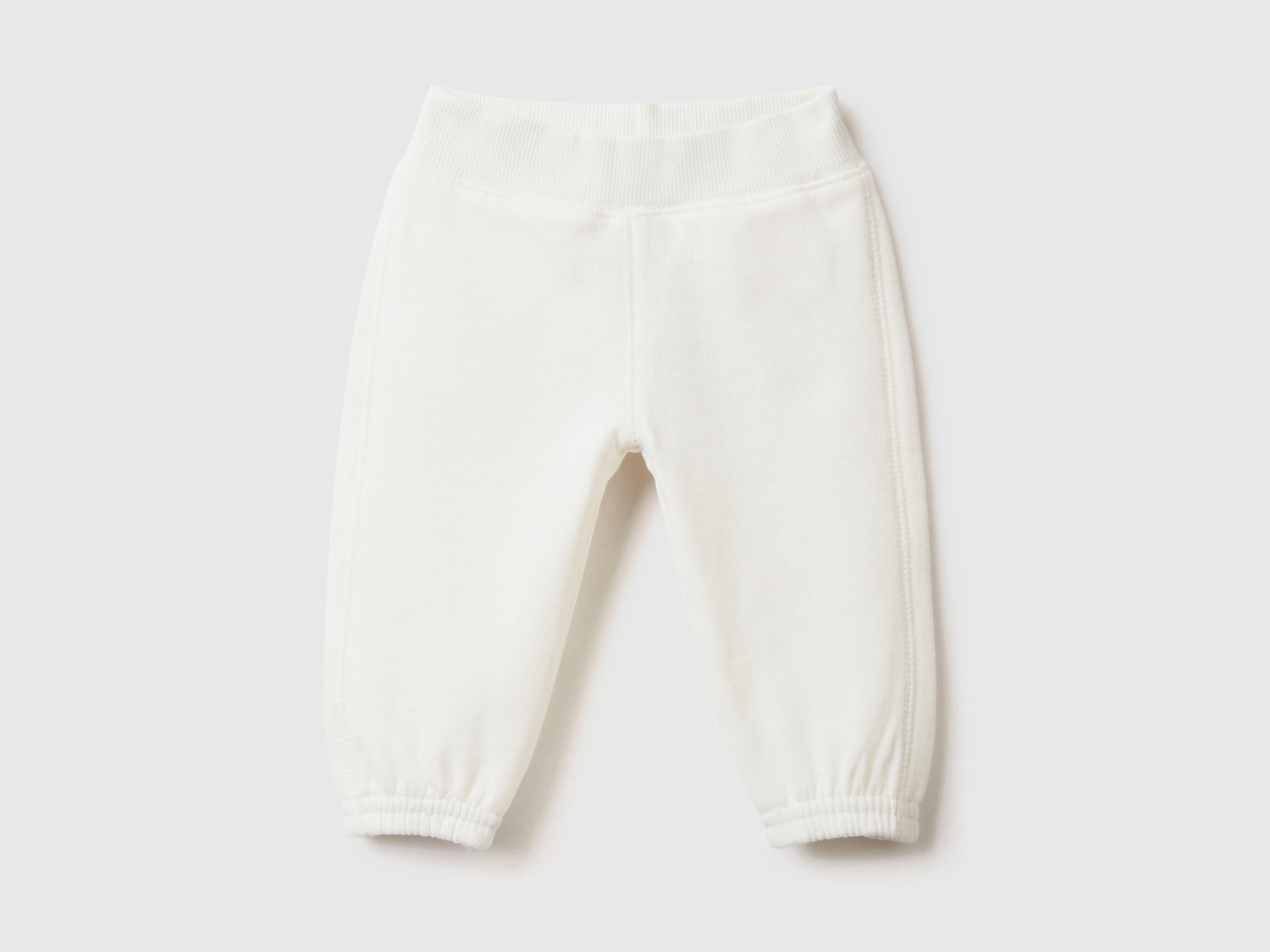 Pantaloni lunghi in felpa di puro cotone da neonato bianco panna | Benetton Outlet