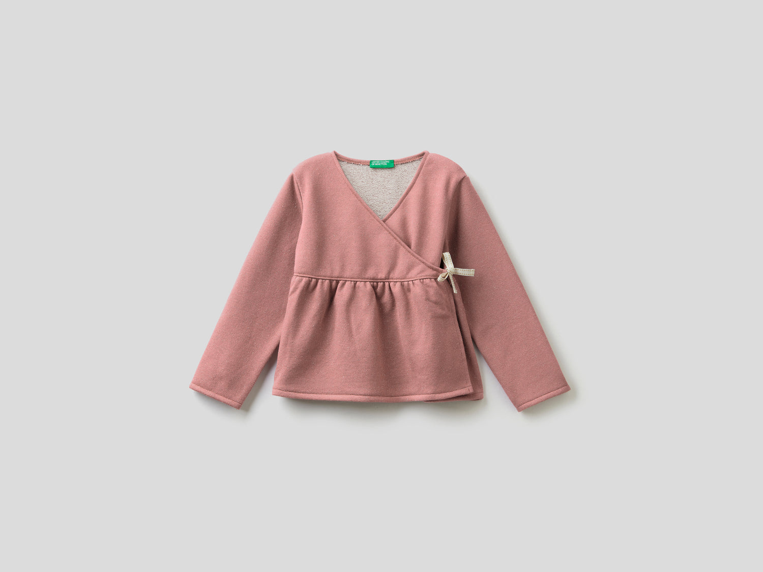 Felpa incrociata con lurex da bimba rosa tenue | Benetton Outlet