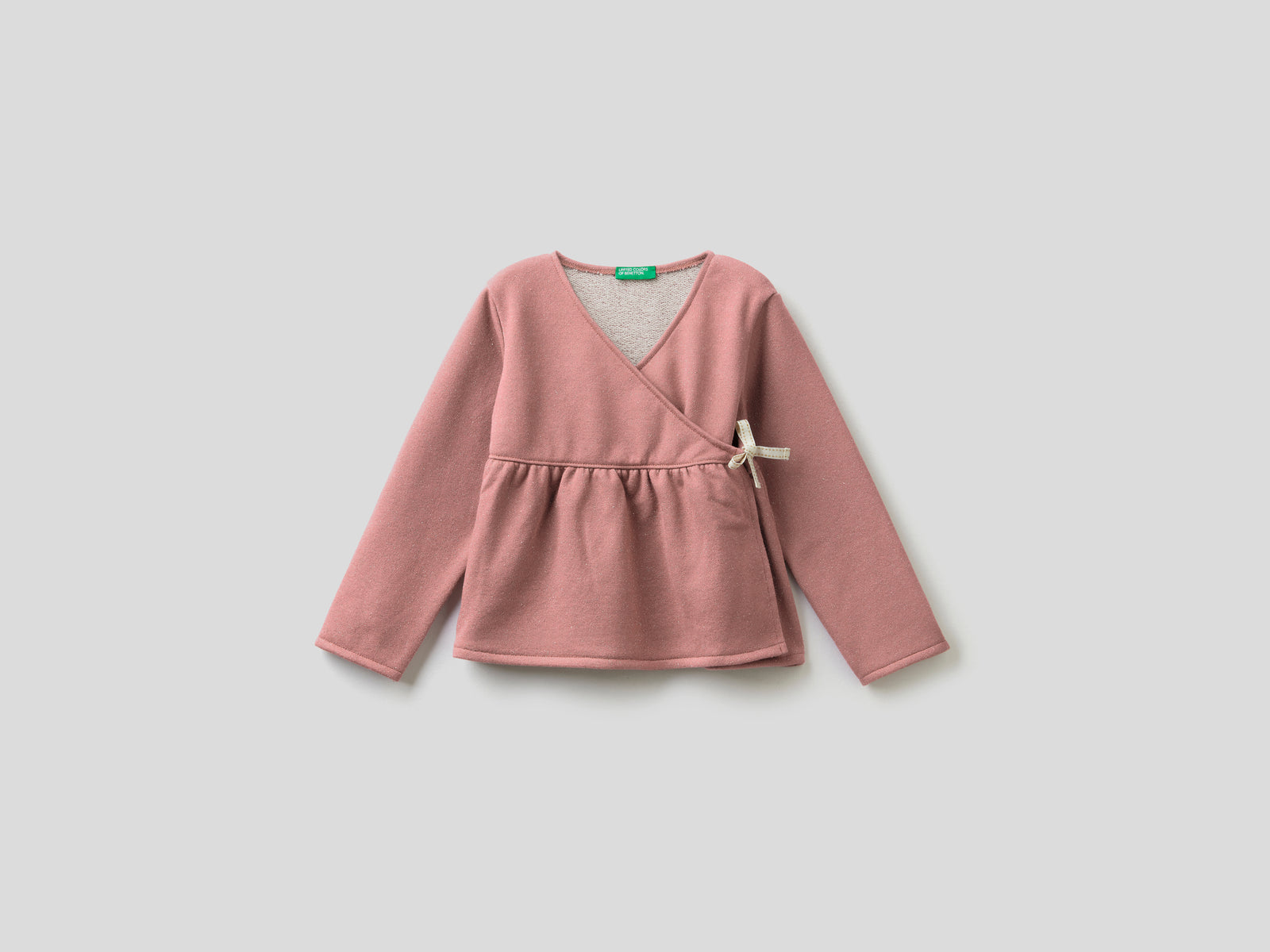 Felpa incrociata con lurex da bimba rosa tenue | Benetton Outlet