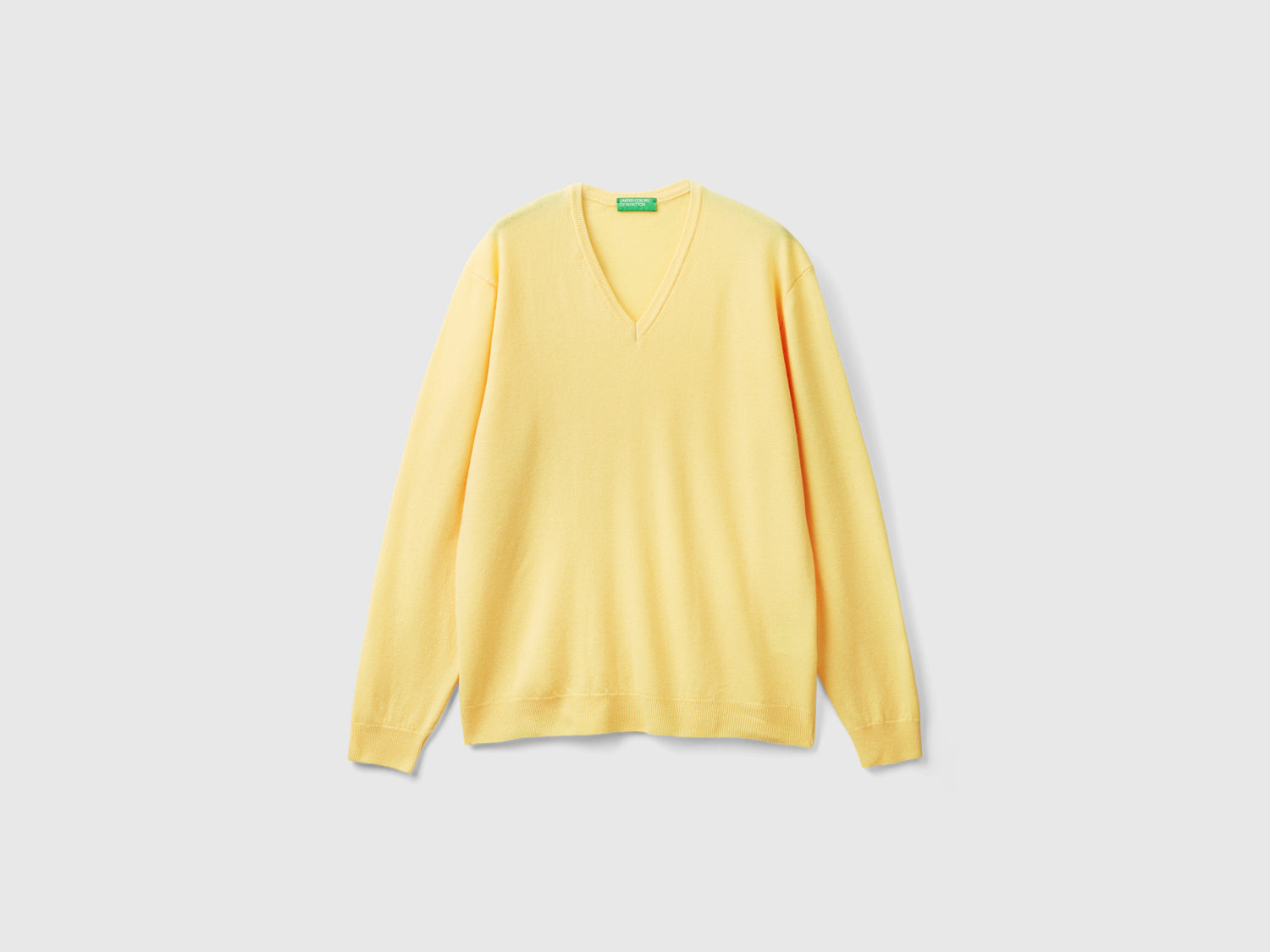 Maglia scollo a V in pura lana Merino da uomo giallo | Benetton Outlet