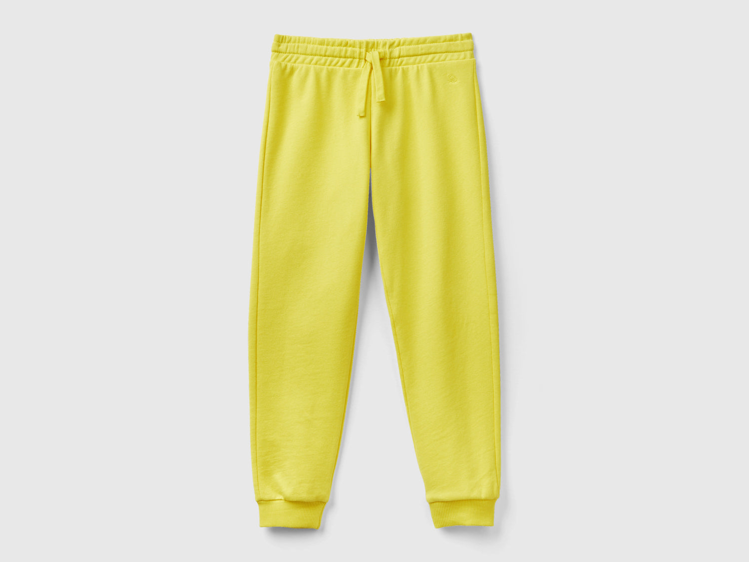 Pantaloni in felpa con logo da bambina giallo | Benetton Outlet