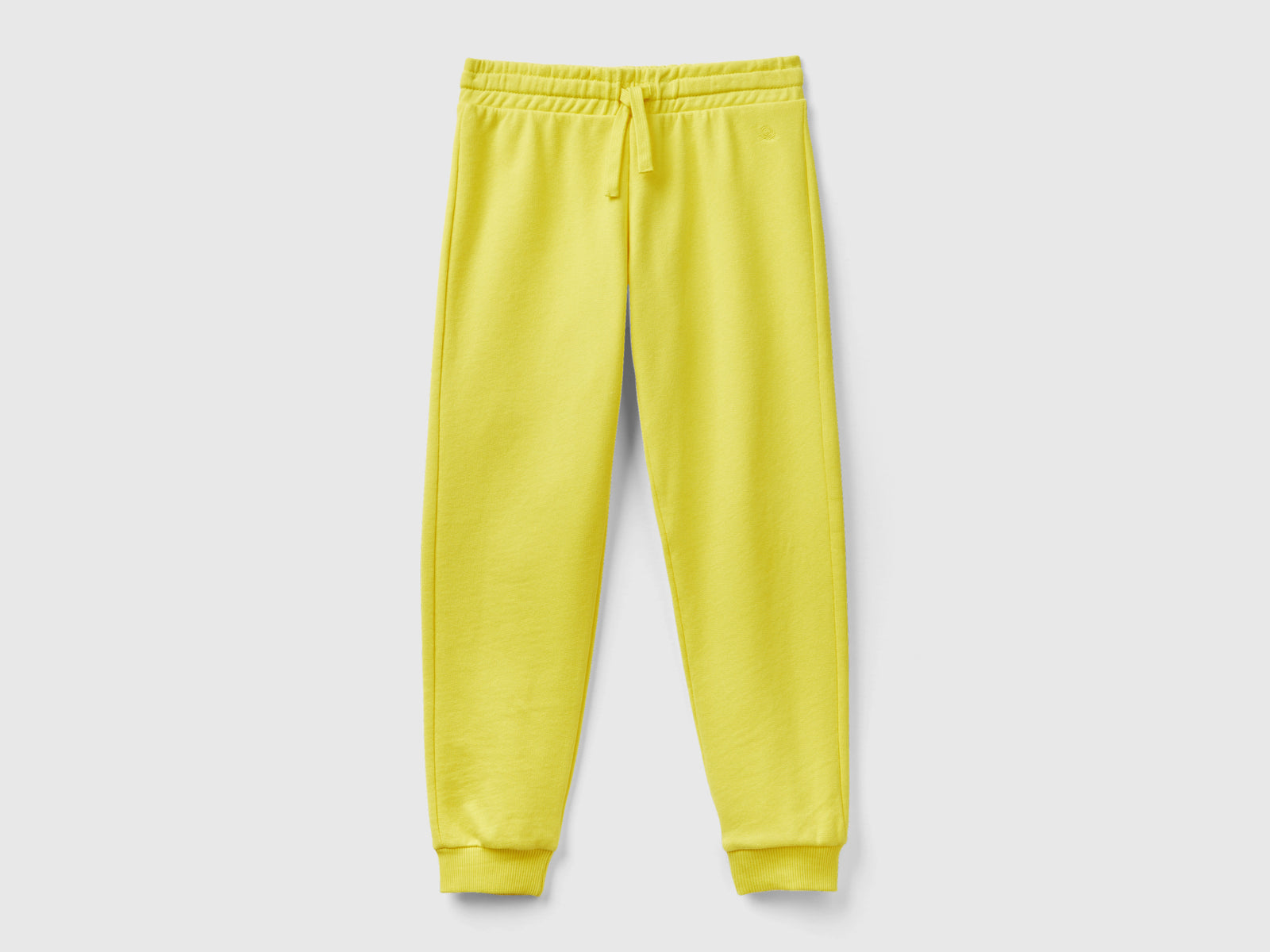 Pantaloni in felpa con logo da bambina giallo | Benetton Outlet