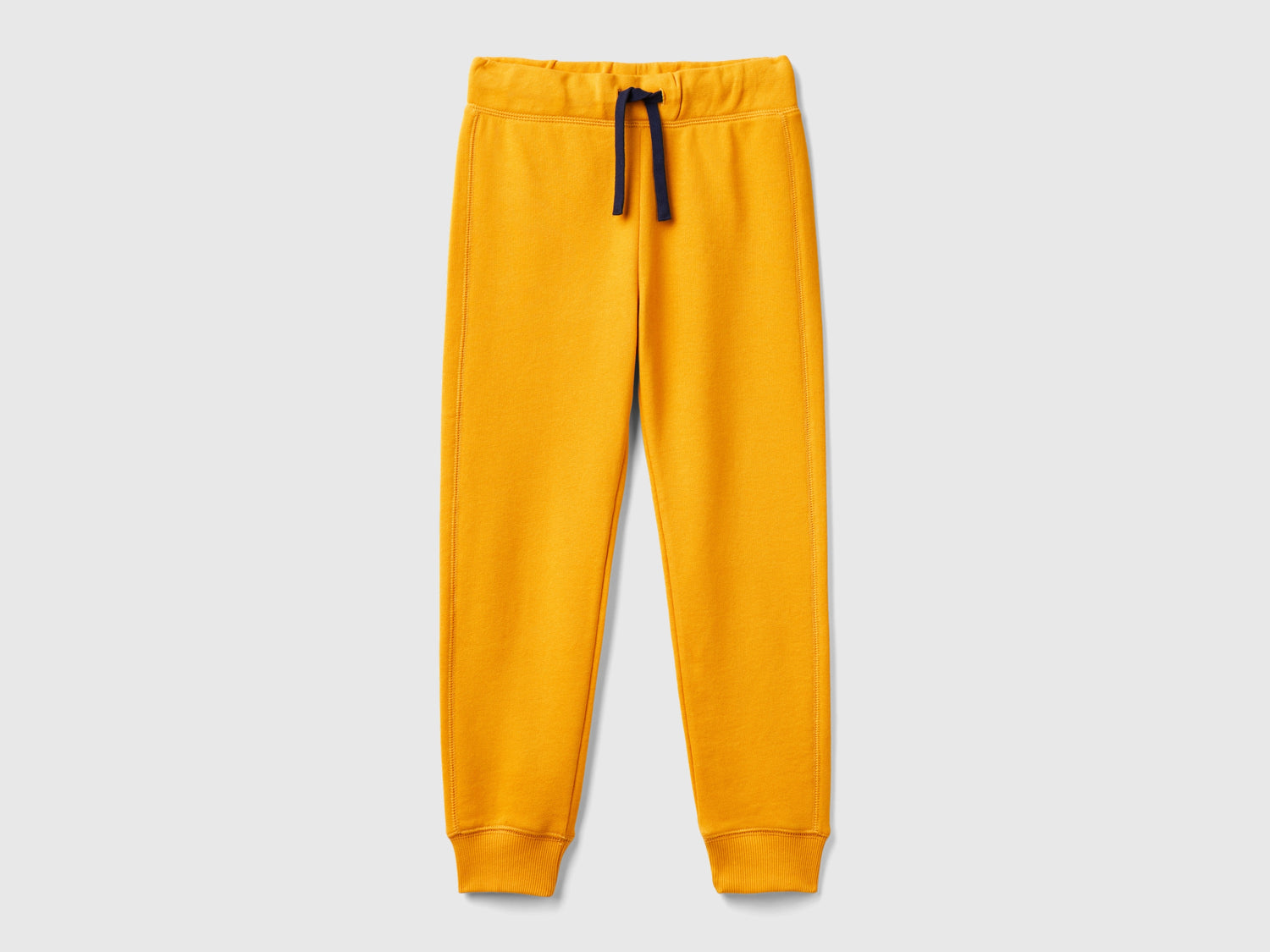 Pantaloni in felpa 100% cotone da bambino senape | Benetton Outlet