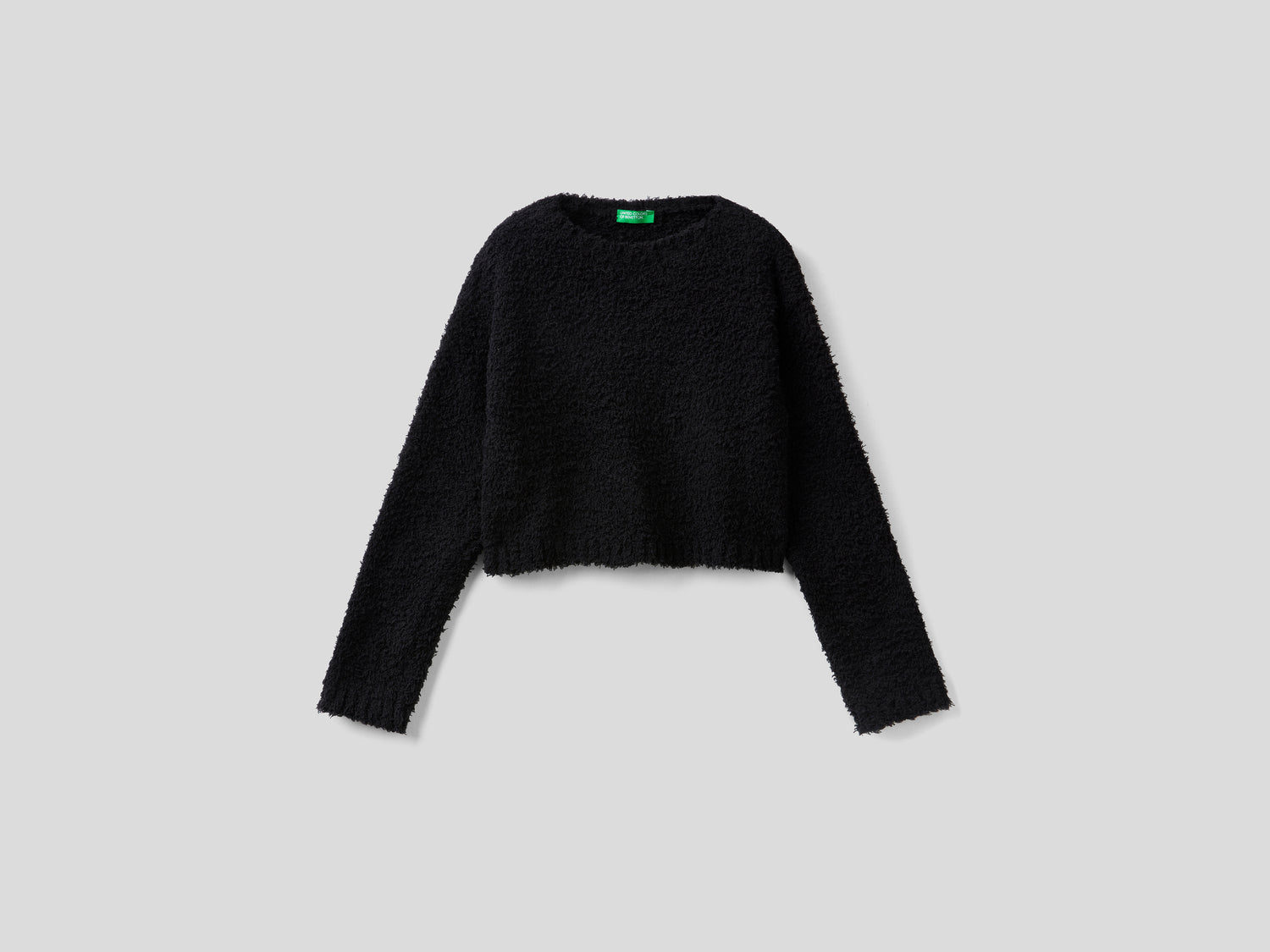 Maglia cropped effetto bouclé da bambina nero | Benetton Outlet