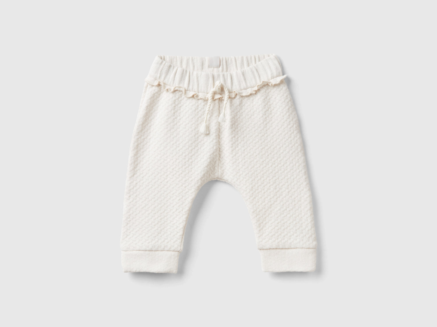 Pantaloni jacquard con spacchetti da neonato bianco panna | Benetton Outlet