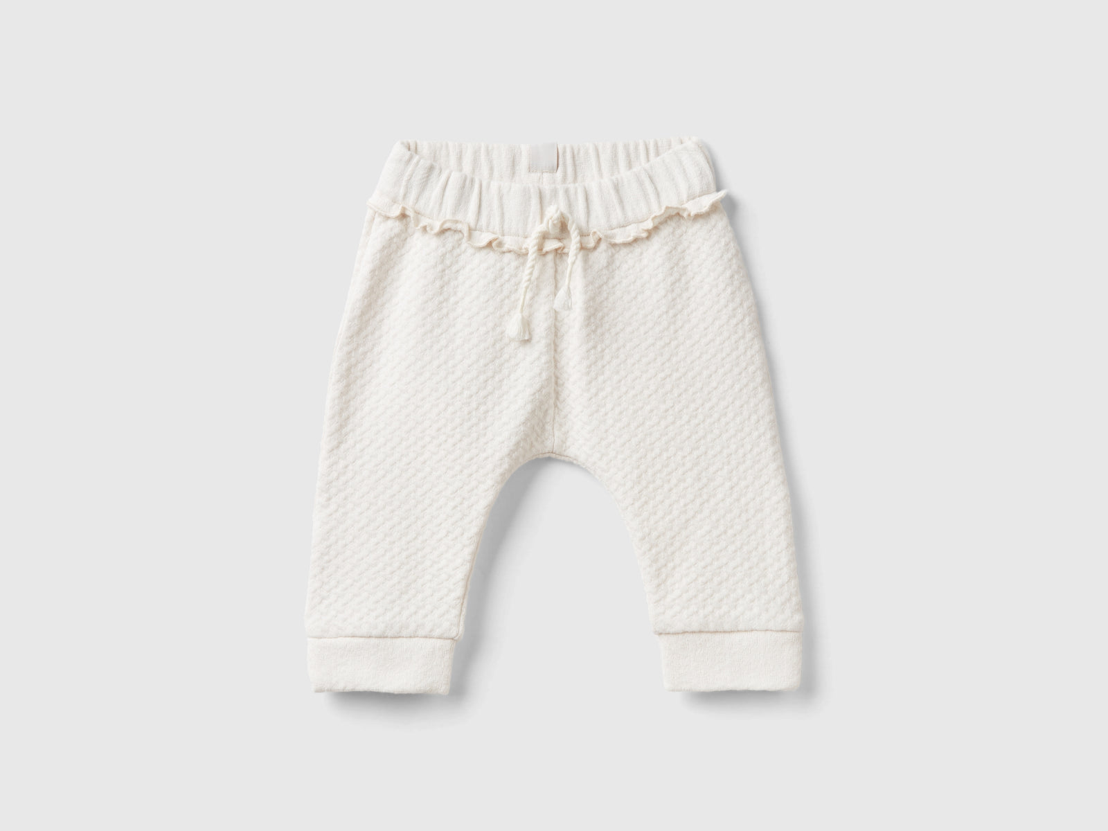 Pantaloni jacquard con spacchetti da neonato bianco panna | Benetton Outlet