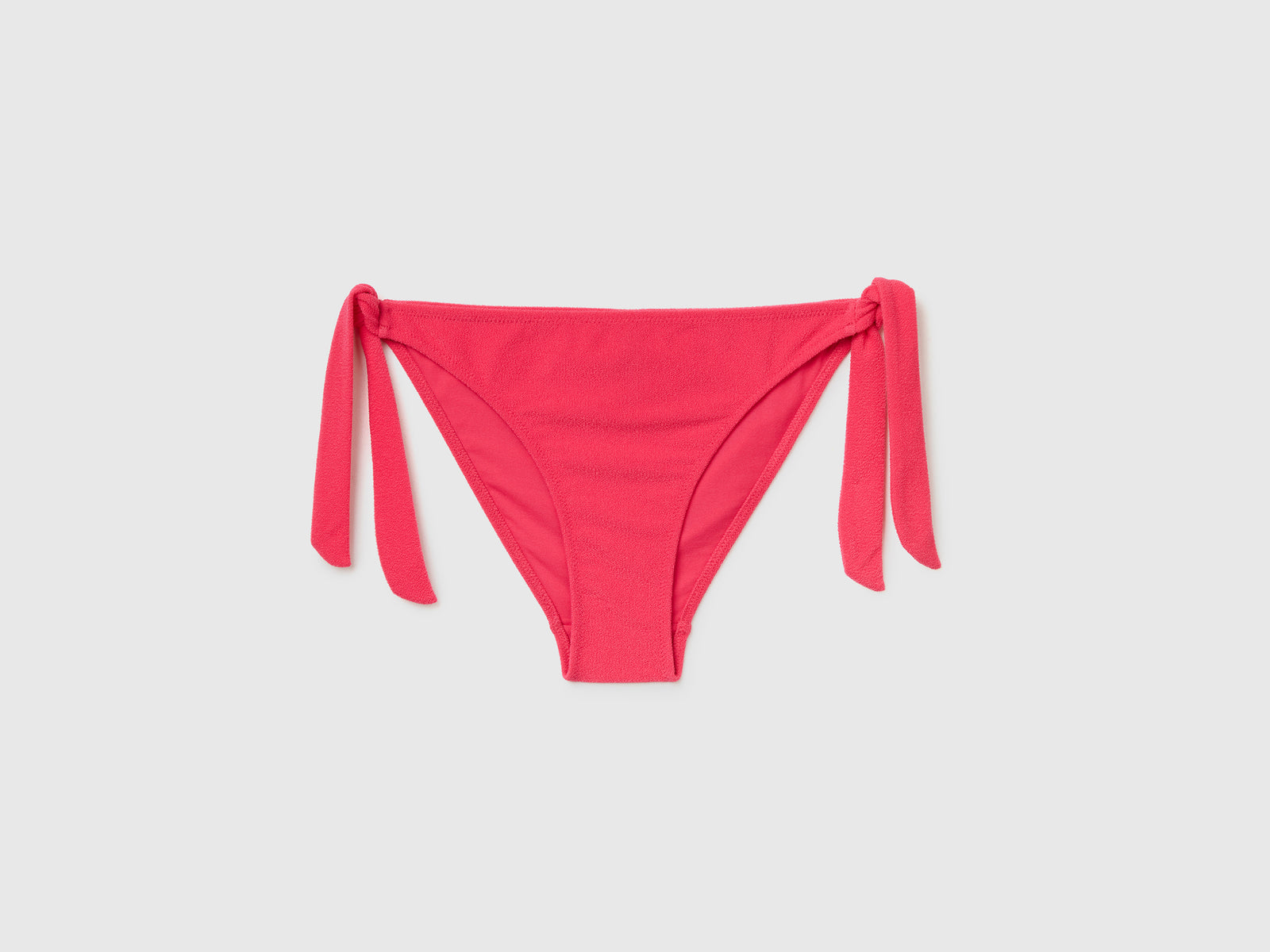 Slip mare con fiocchi sui fianchi in tessuto elasticizzato effetto spugna da donna fucsia | Benetton Outlet