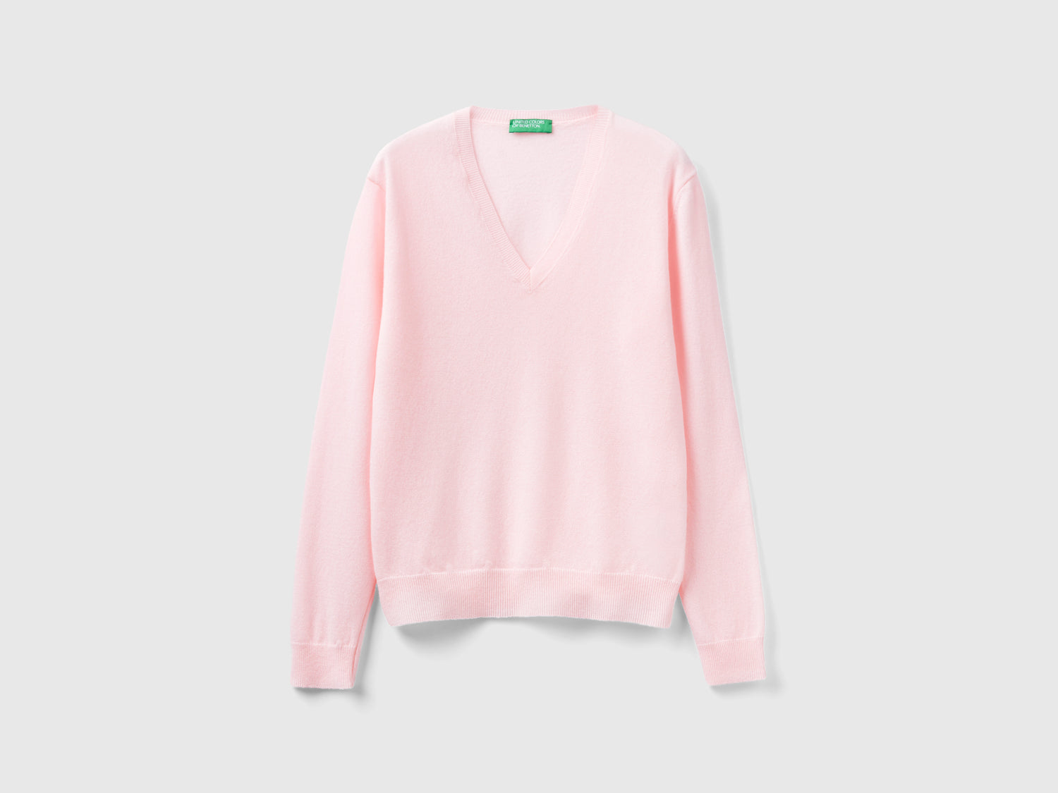 Maglia con scollo a V rosa chiaro in pura lana Merino da donna rosa tenue | Benetton Outlet