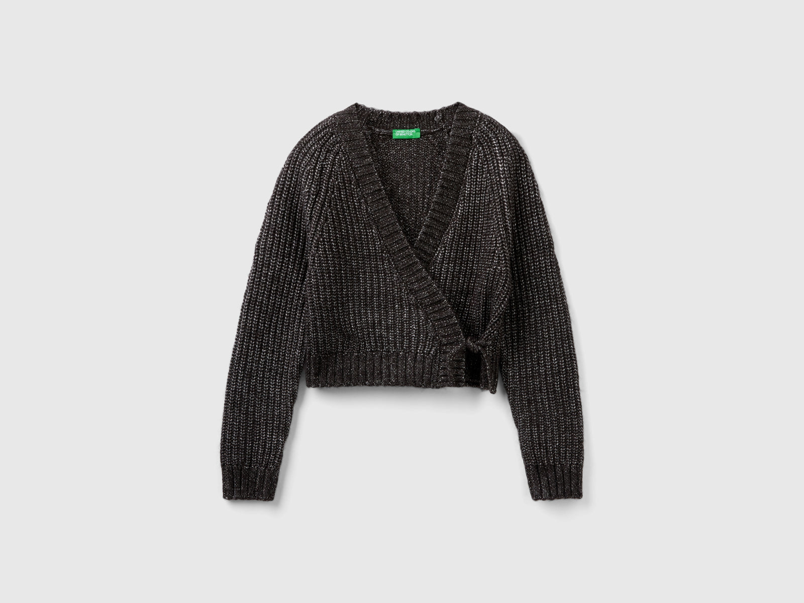 Cardigan incrociato con lurex da bambina nero | Benetton Outlet