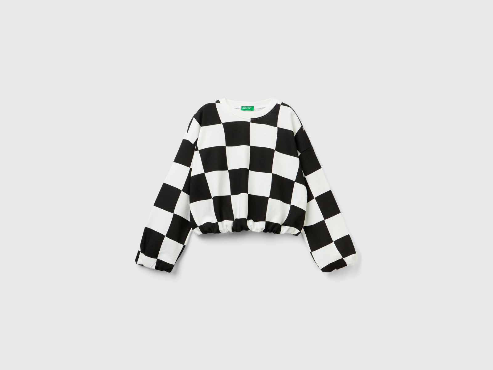 Felpa a scacchi boxy fit da bambina nero | Benetton Outlet