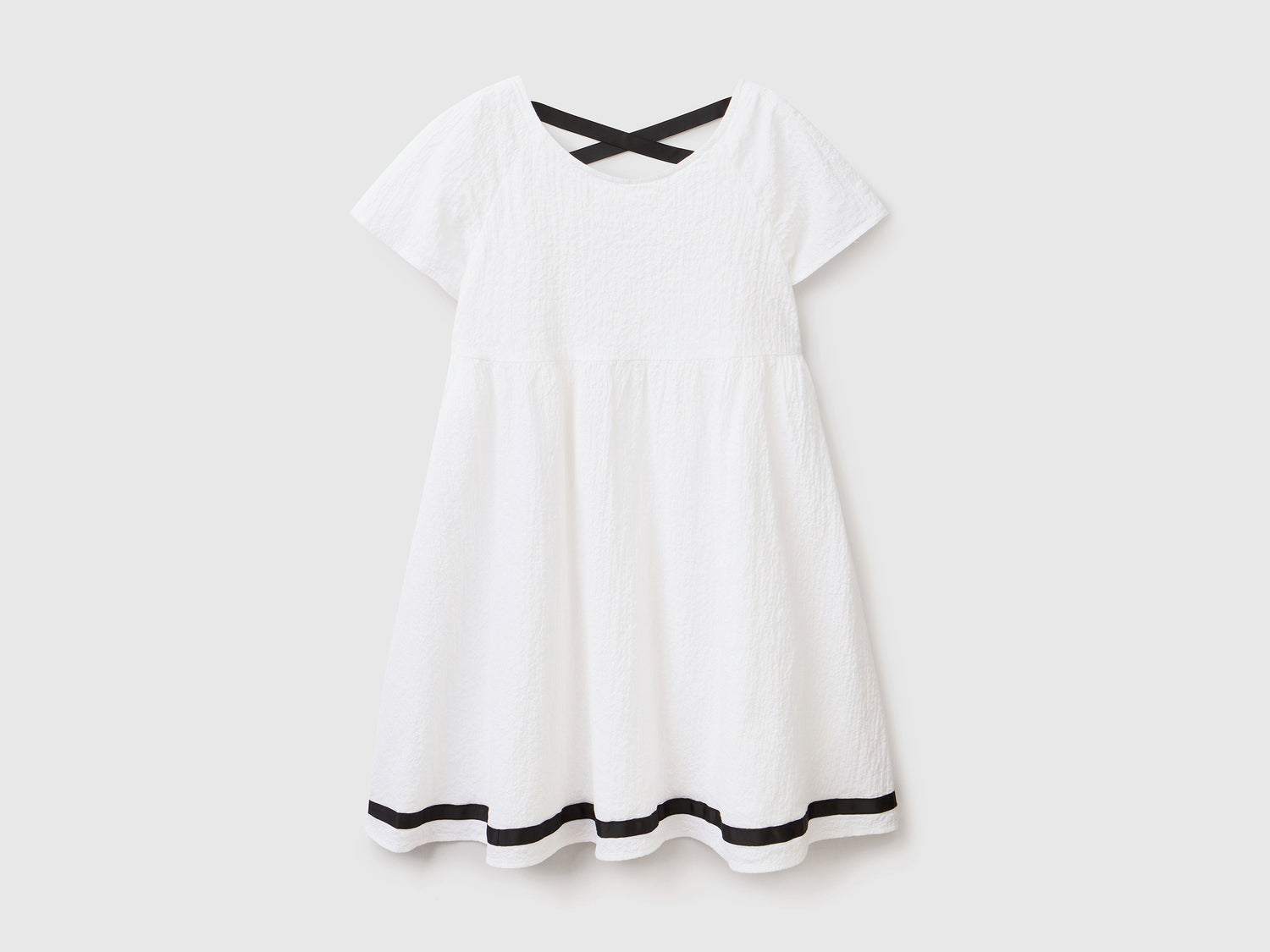 Abito svasato a manica corta in cotone elasticizzato dal peso medio da bambina bianco | Benetton Outlet