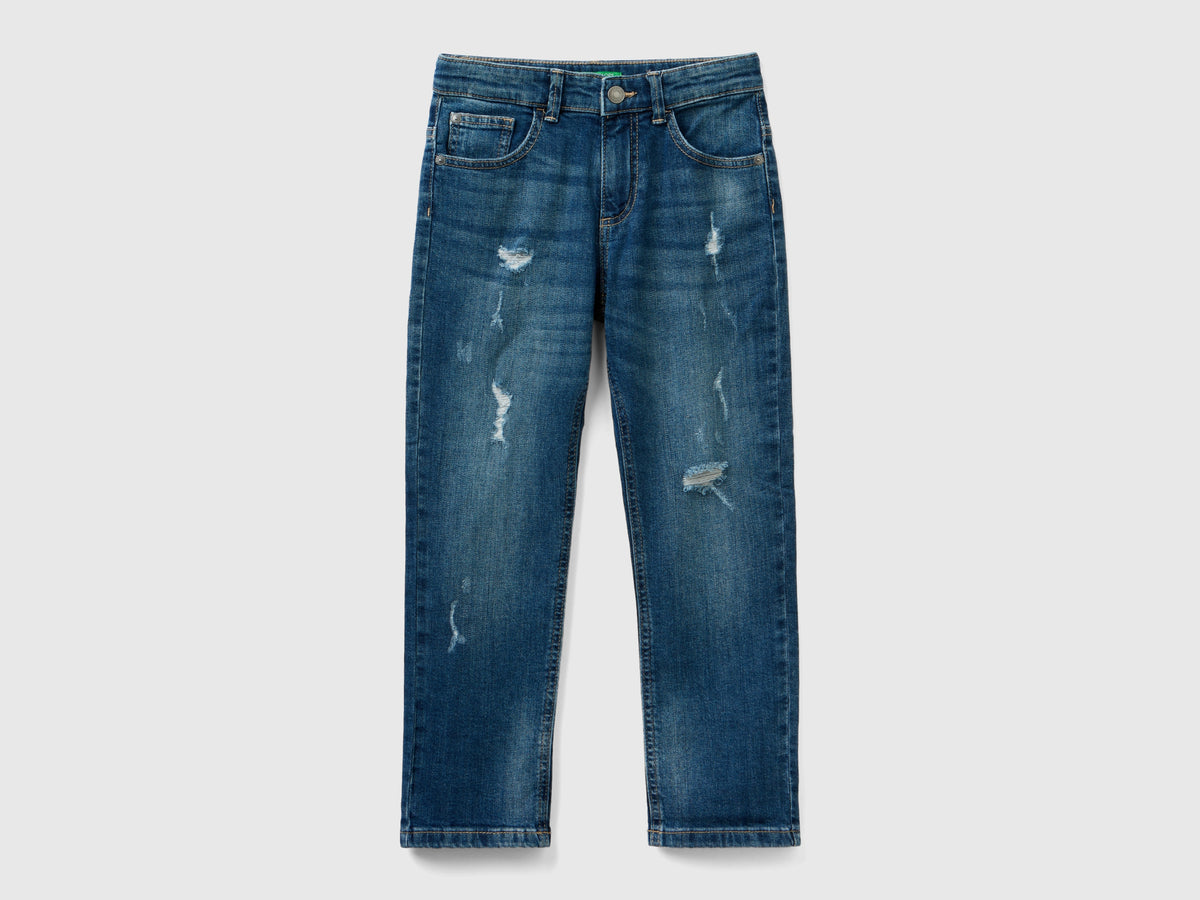Jeans slim fit con rotture