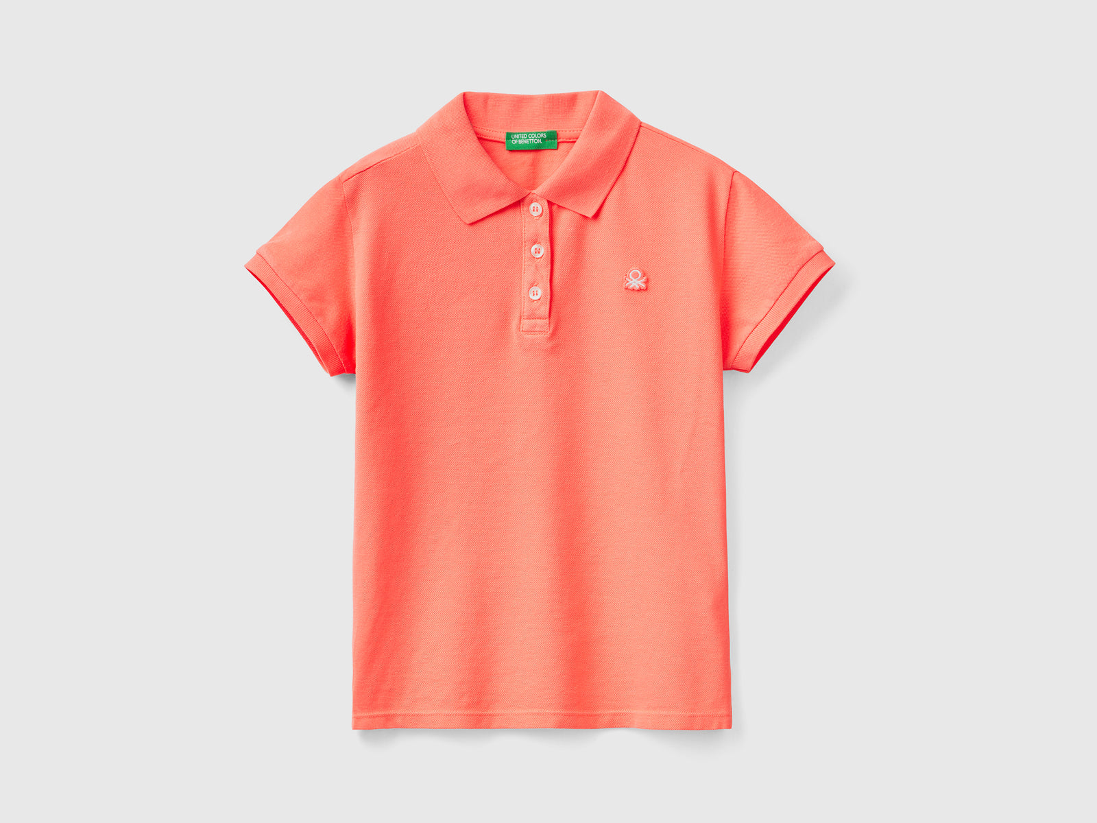 Polo a manica corta in piquet di cotone elasticizzato da bambina arancione | Benetton Outlet