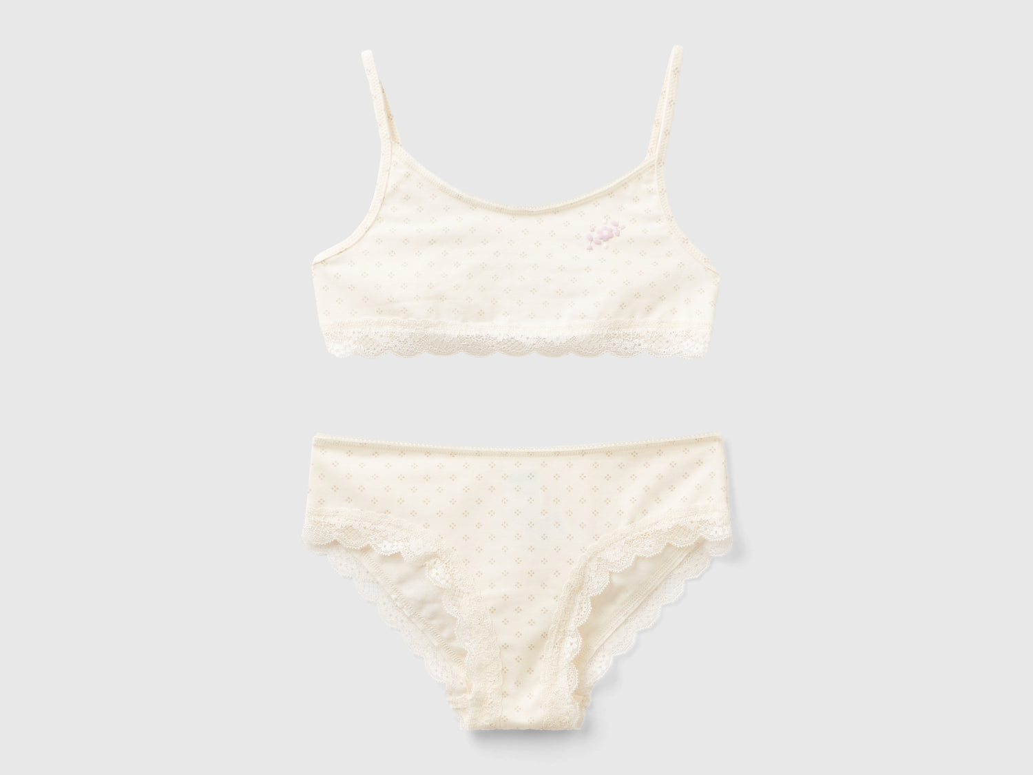 Completo top e slip microfantasia da bambina bianco panna | Benetton Outlet