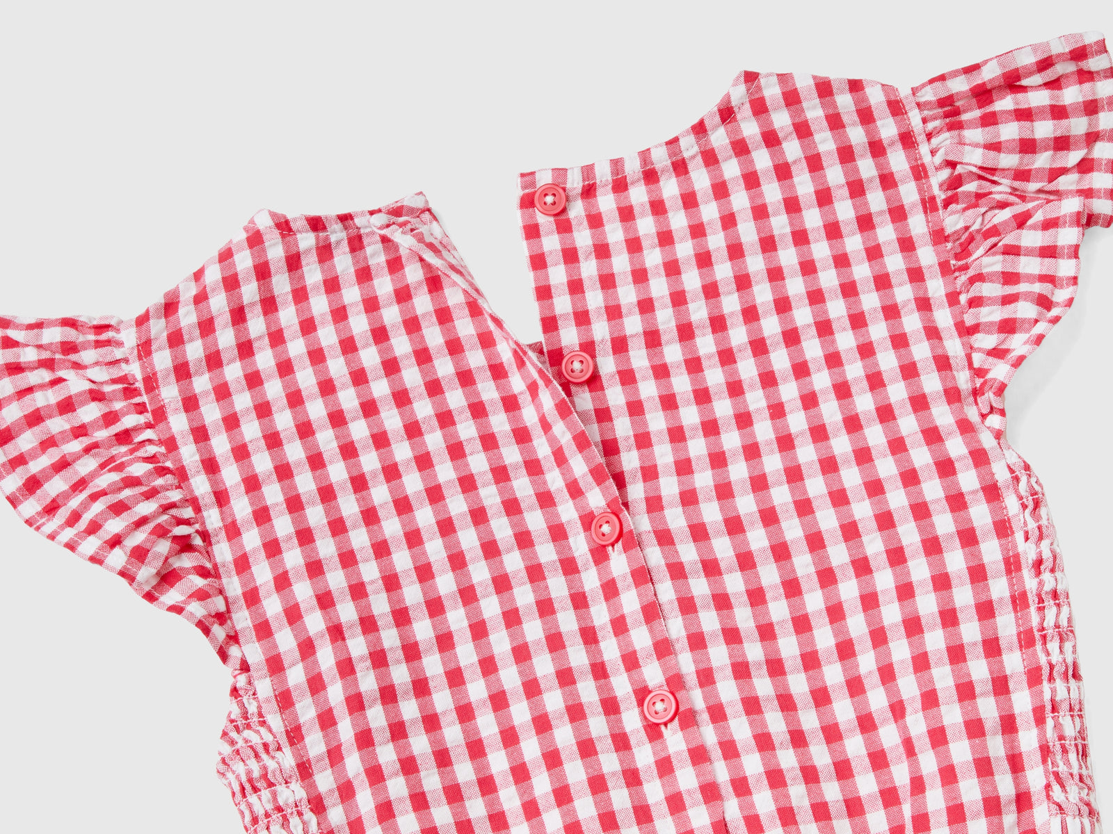 Tuta vichy con alette da bambina fucsia 2 | Benetton Outlet