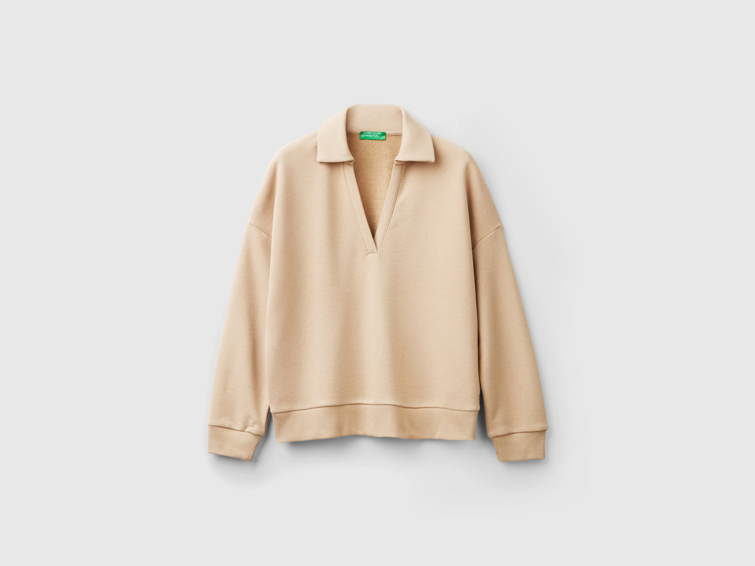 Polo in felpa con scollo a V da donna beige | Benetton Outlet