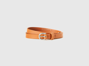 Low-slung patent leather-effect belt