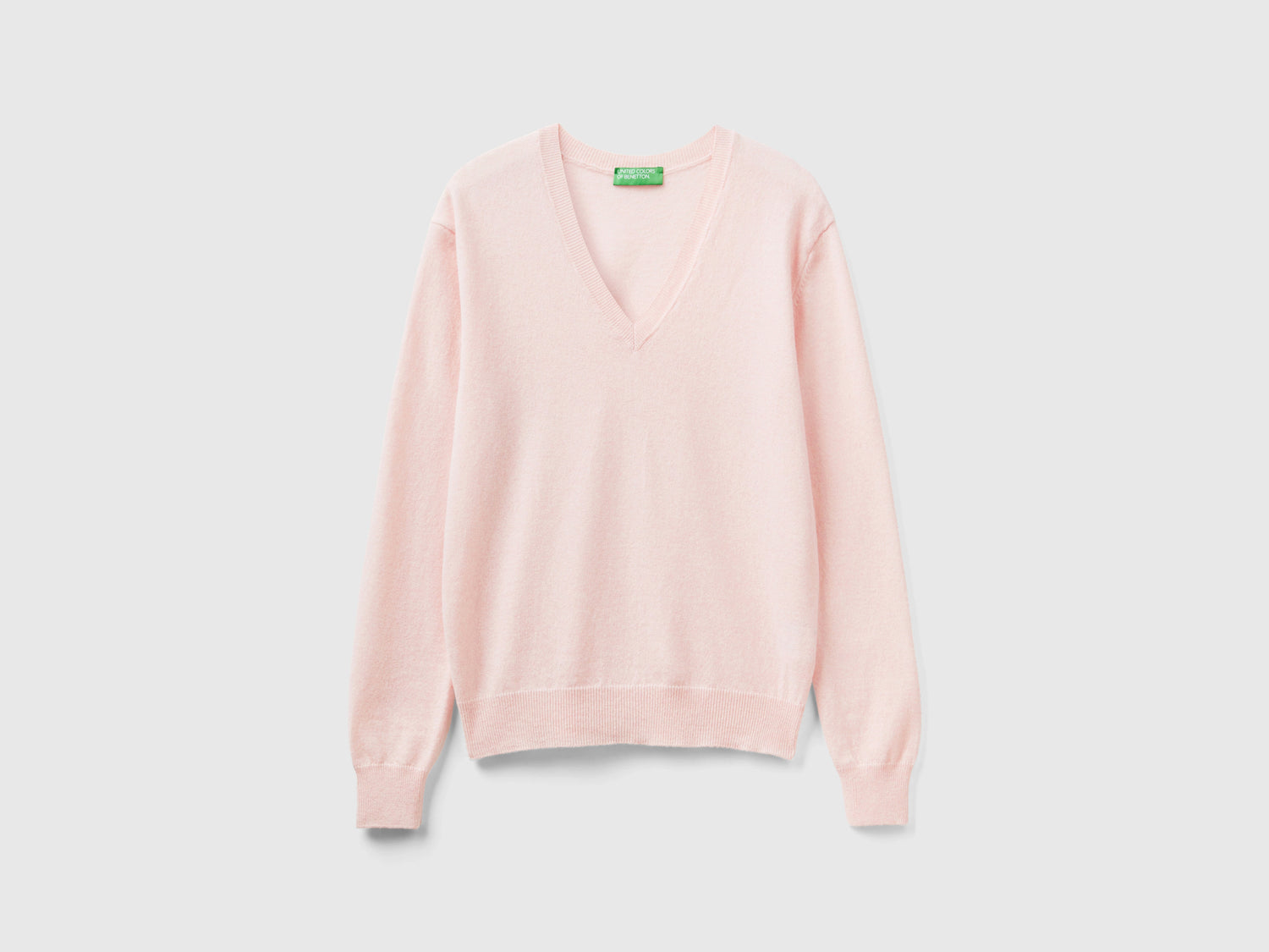 Maglia con scollo a V in pura lana Merino da donna rosa pastello | Benetton Outlet
