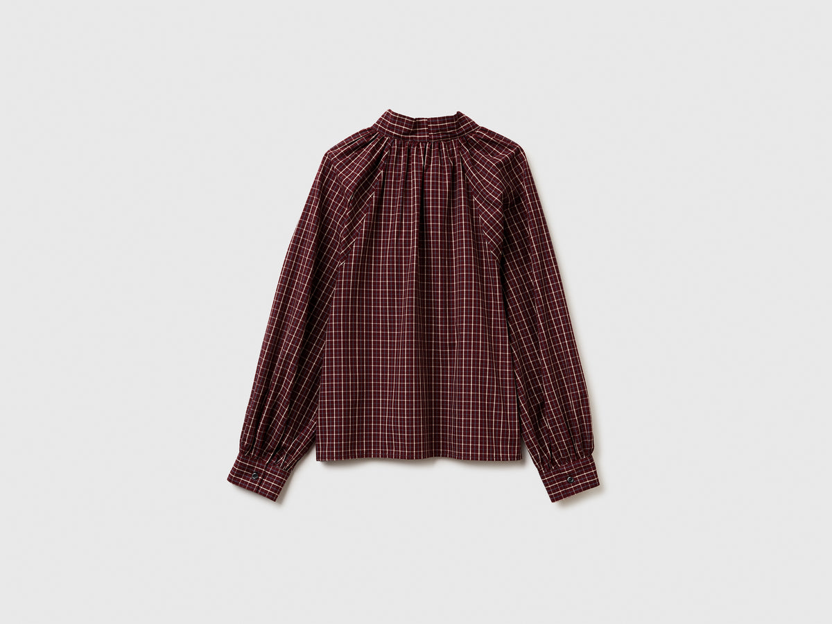 Blusa a quadri con fiocco
