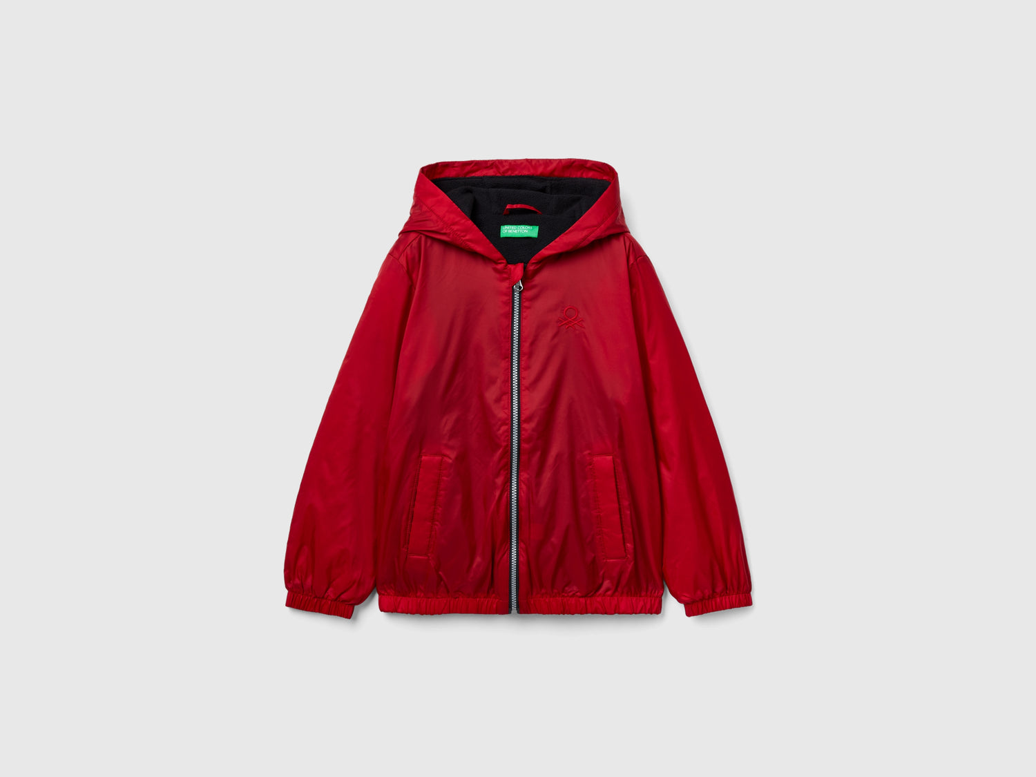 Giubbino in nylon con zip e cappuccio da bambino rosso | Benetton Outlet