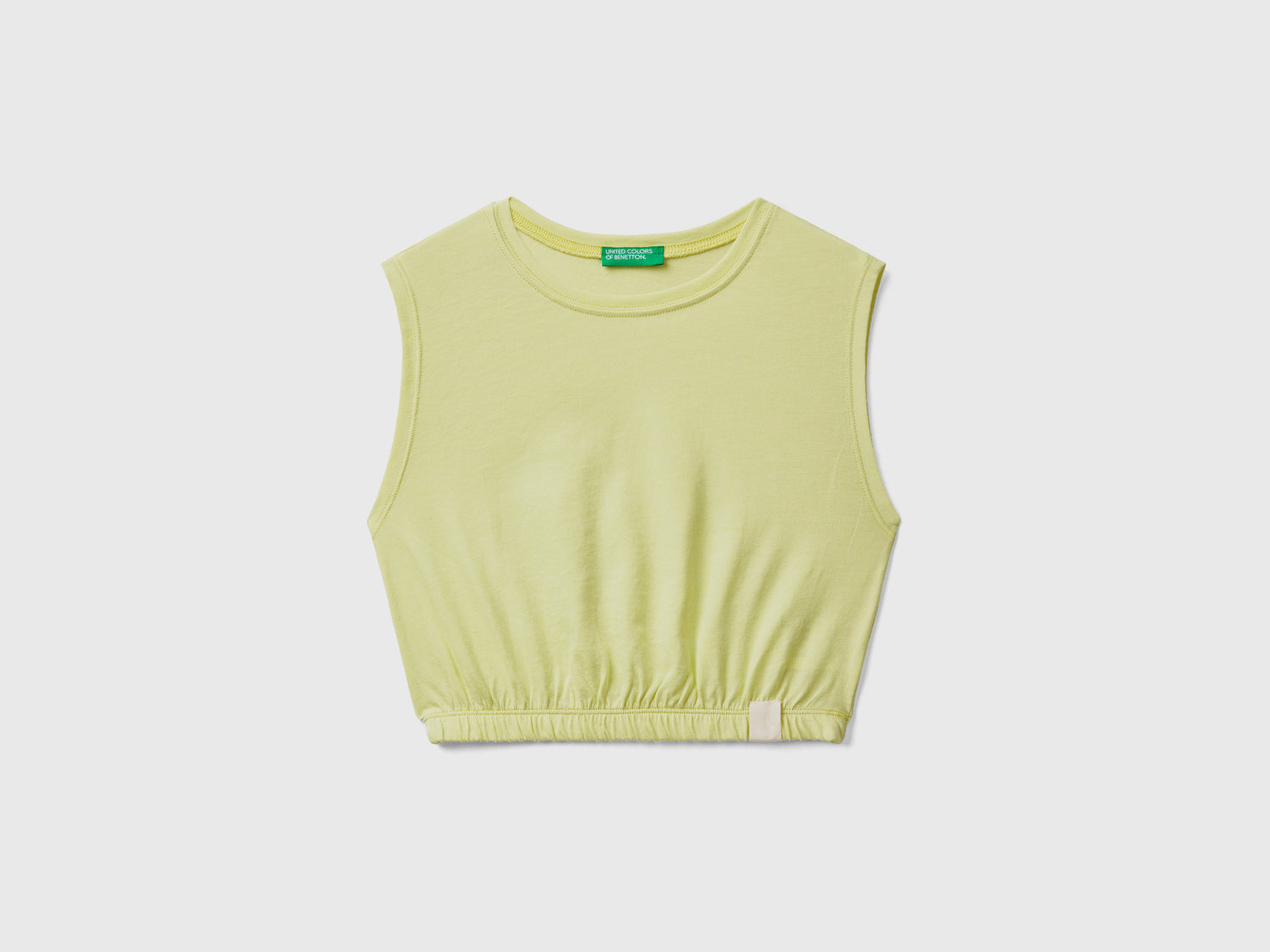 Top corto smanicato con scollo rotondo ed elastico interno sul fondo da bambina giallo | Benetton Outlet