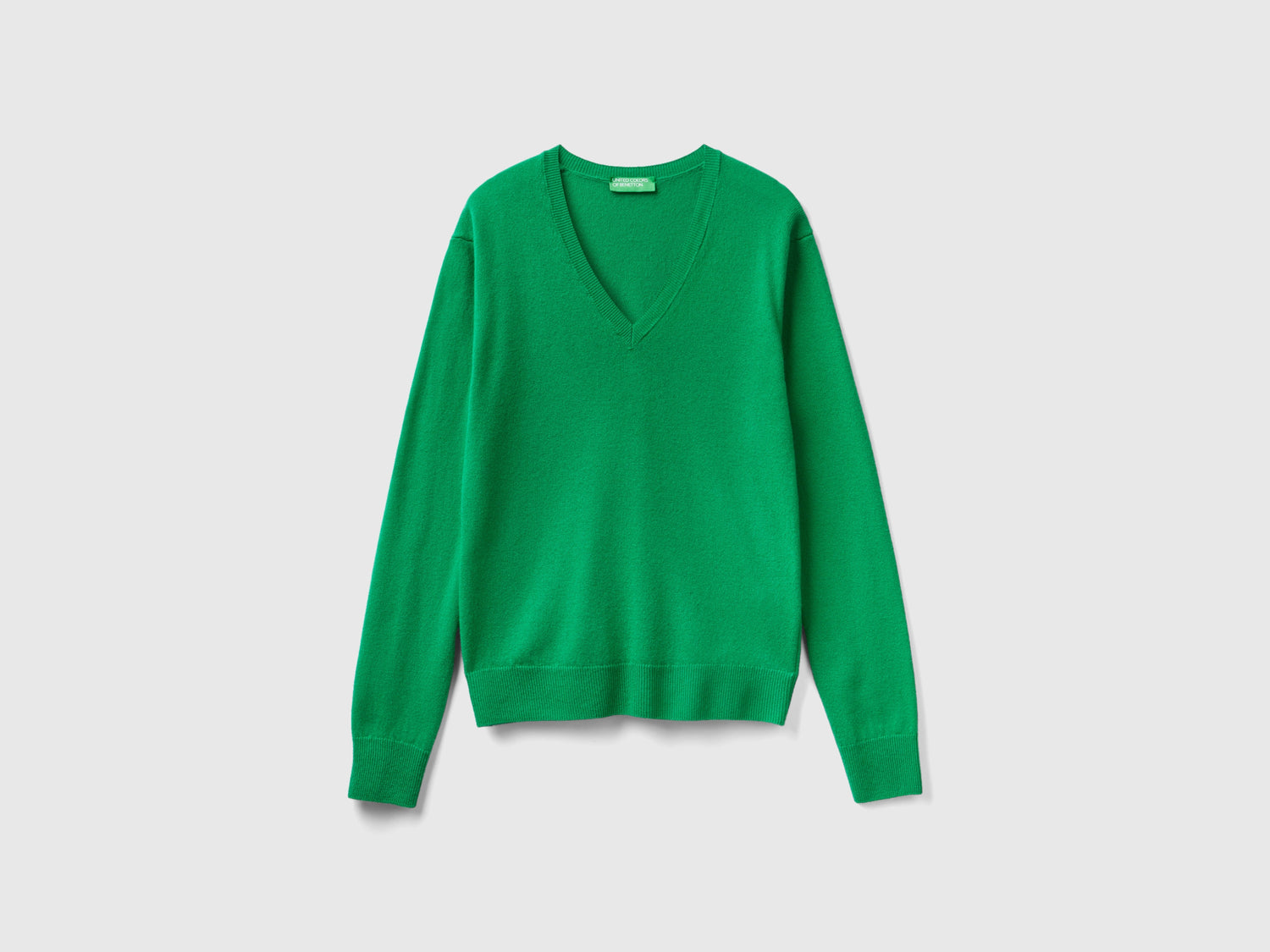 Maglia con scollo a V in pura lana Merino da donna verde | Benetton Outlet