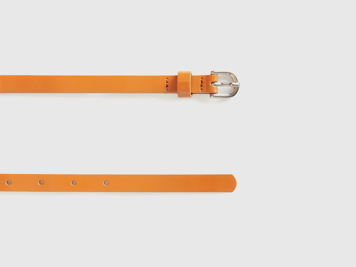 Low-slung patent leather-effect belt