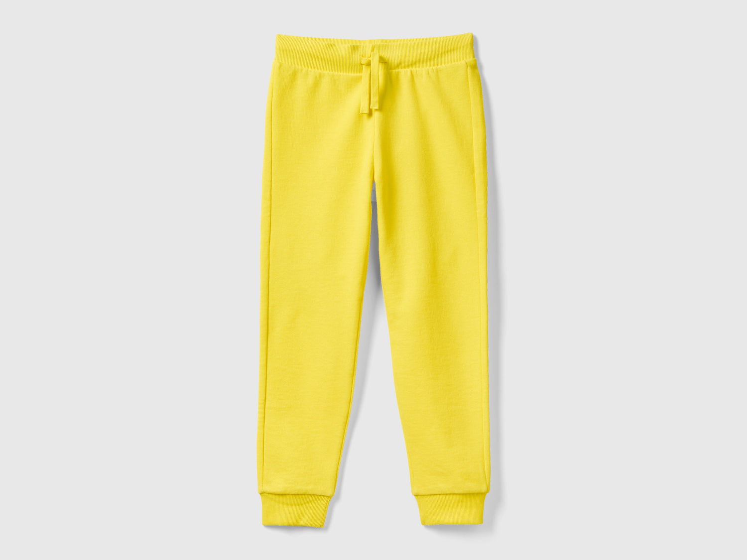 Pantaloni sportivi con coulisse da bambino giallo | Benetton Outlet