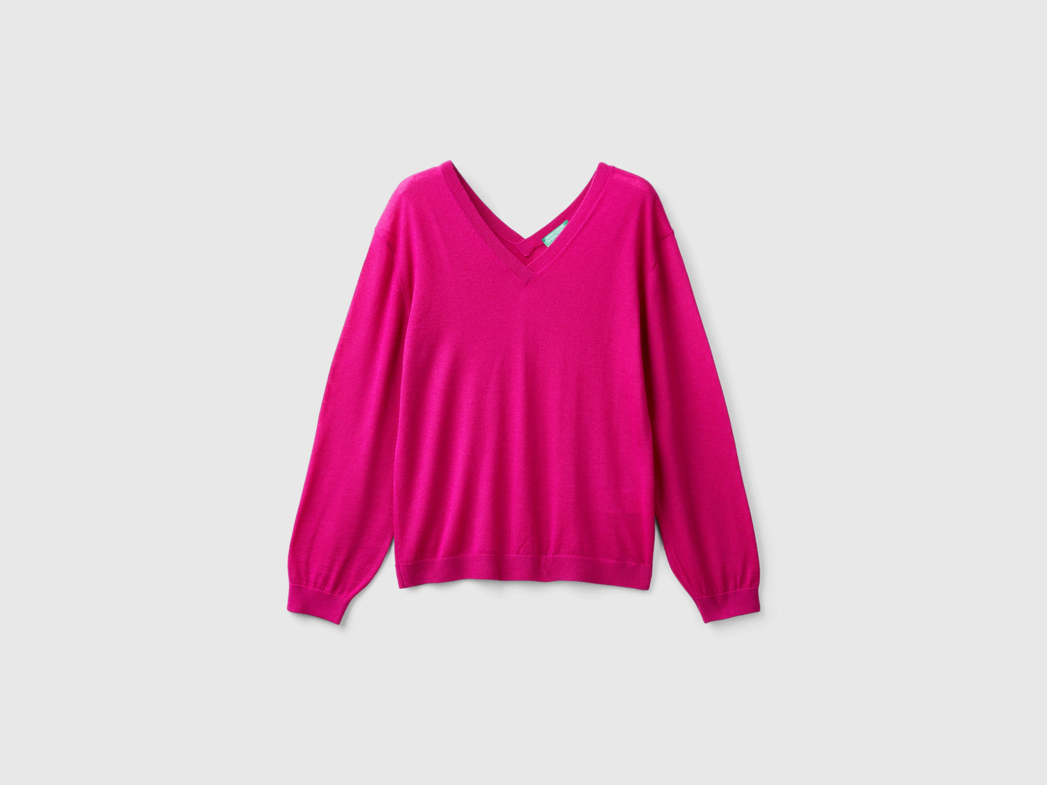 Maglia scollo a V in pura lana Merino da donna ciclamino | Benetton Outlet
