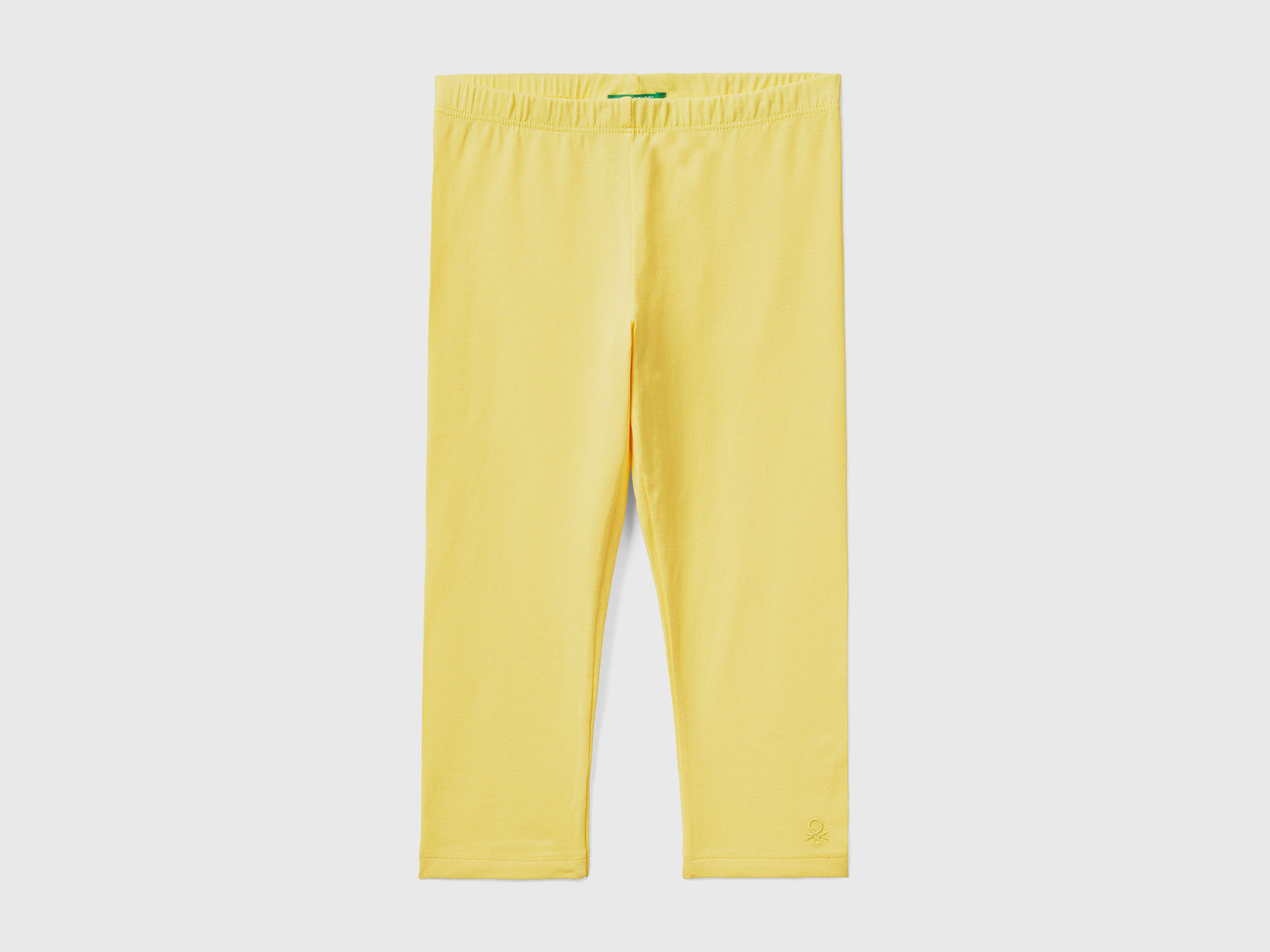 Leggings in cotone elasticizzato con lunghezza al ginocchio da bambina giallo | Benetton Outlet