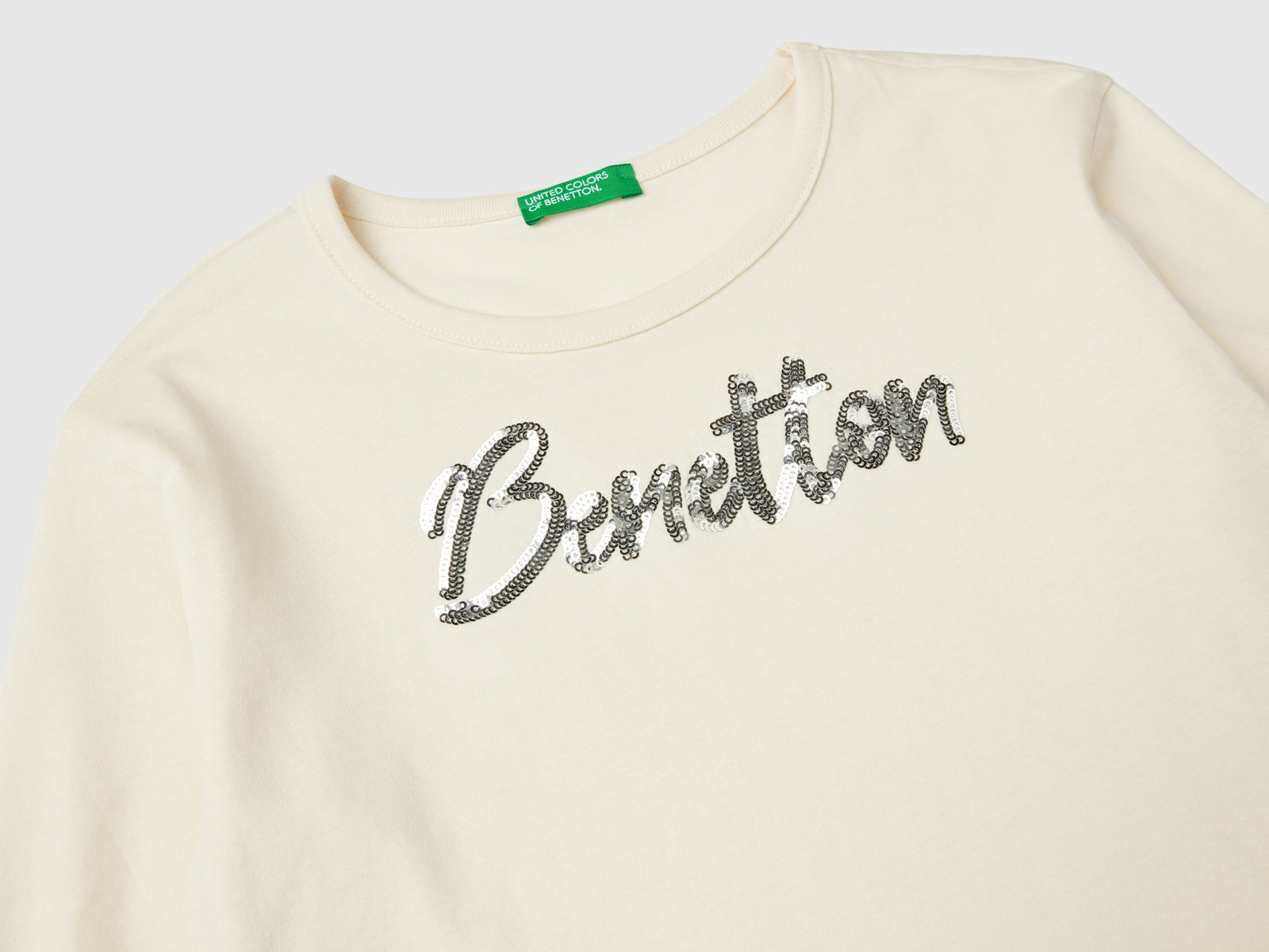 T-shirt in caldo cotone bio con paillettes da bambina bianco panna 3 | Benetton Outlet