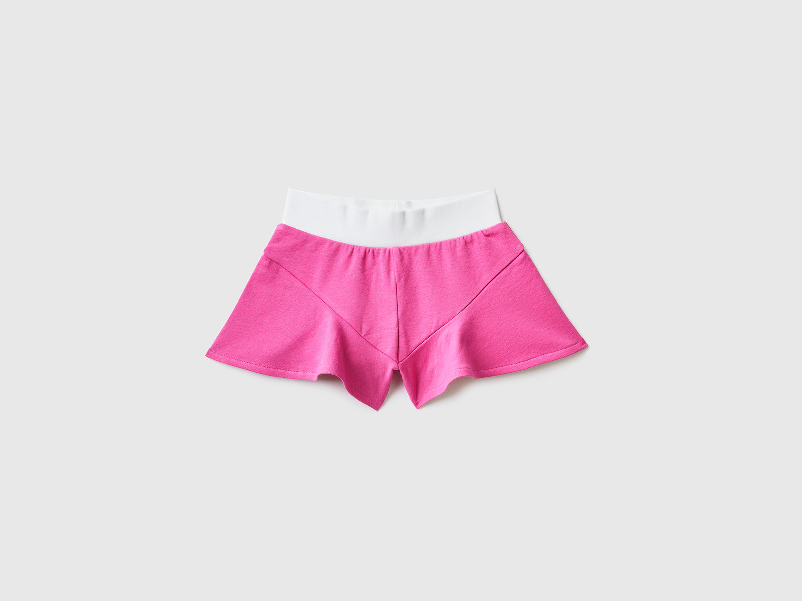 Pantaloni corti in felpa di cotone elasticizzato da bambina fucsia | Benetton Outlet