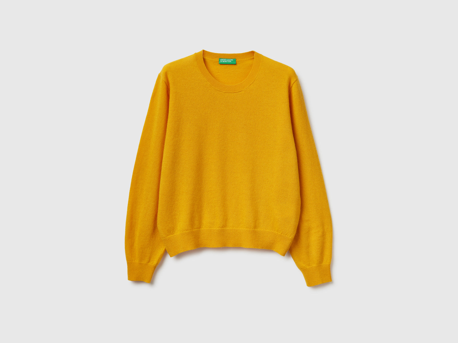 Maglia relaxed fit in pura lana Merino da donna senape | Benetton Outlet