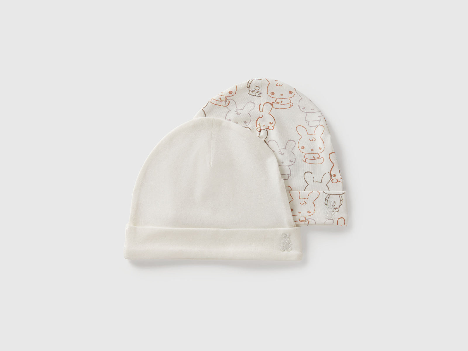 Due cappelli in cotone da neonato bianco panna | Benetton Outlet