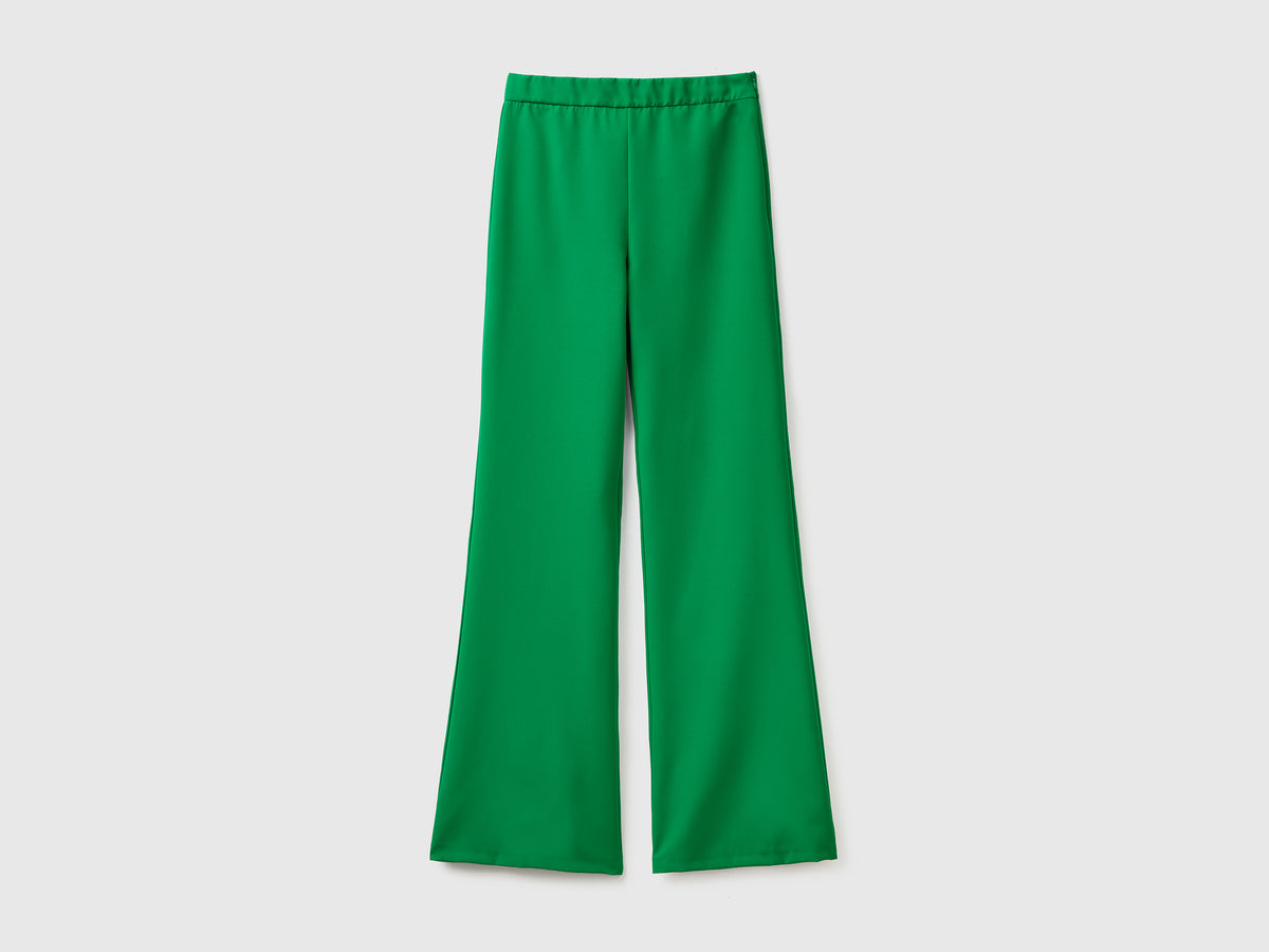 Pantaloni lunghi in tessuto elasticizzato con gamba svasata sul fondo