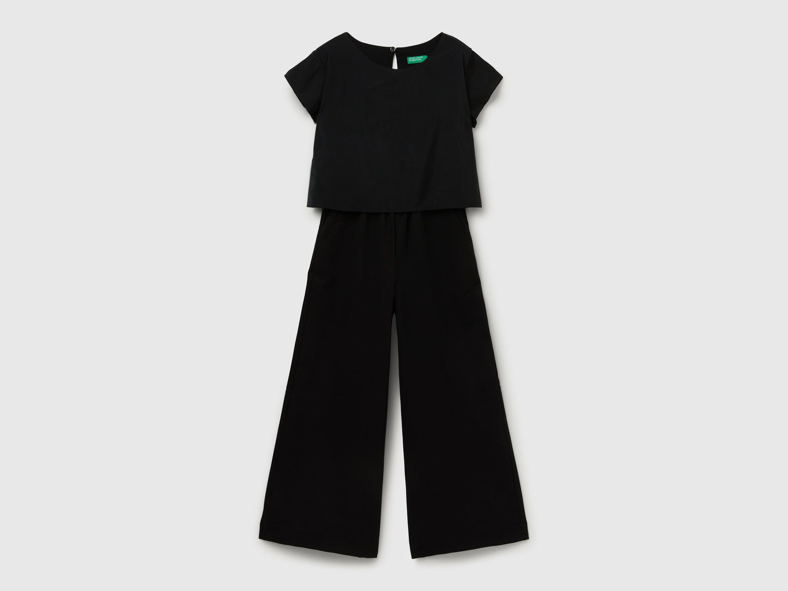 Tuta fluida a manica corta da bambina nero | Benetton Outlet